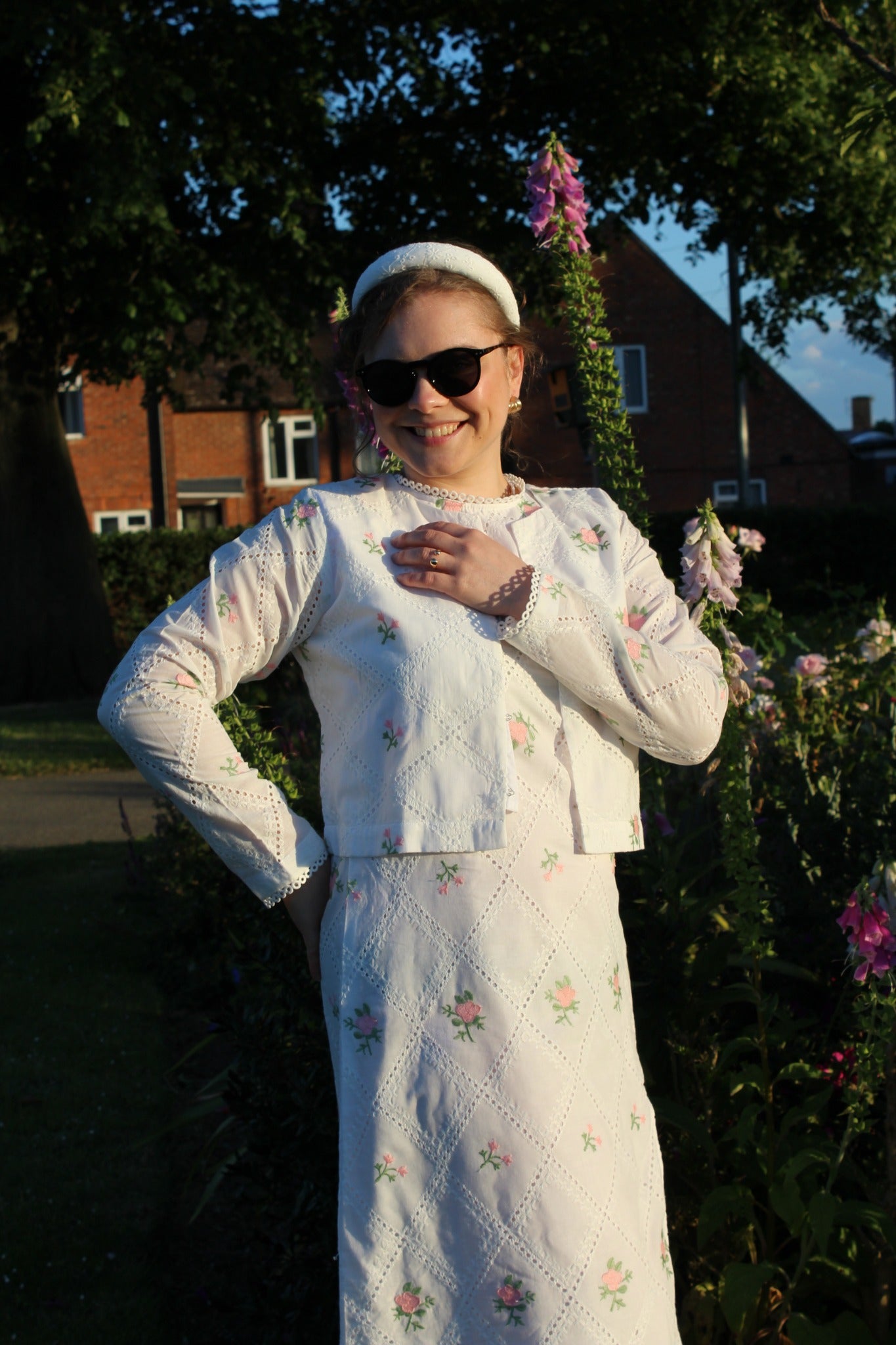 Woman in a white embroidered dress Cropped pink embroidered cardigan-Relaxed body fit-Round neck -Inside hidden hook closure-full lined body with100% soft fine cotton-Long sleeves with lace -Fabric: 100% Cotton-sideangle