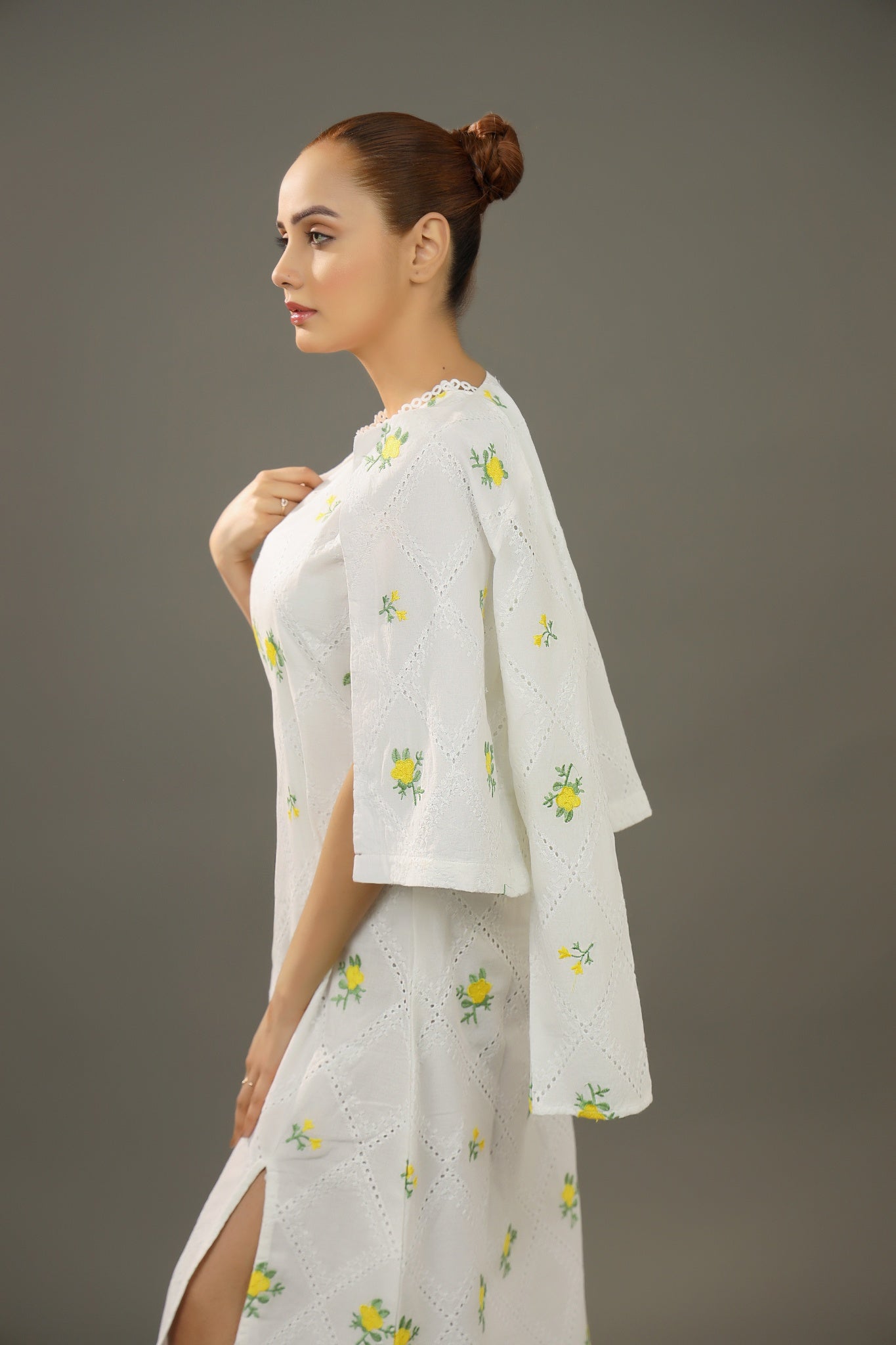 A woman Wearing an Organic-_cotton-white-summer-woman-dress-yellow-floral