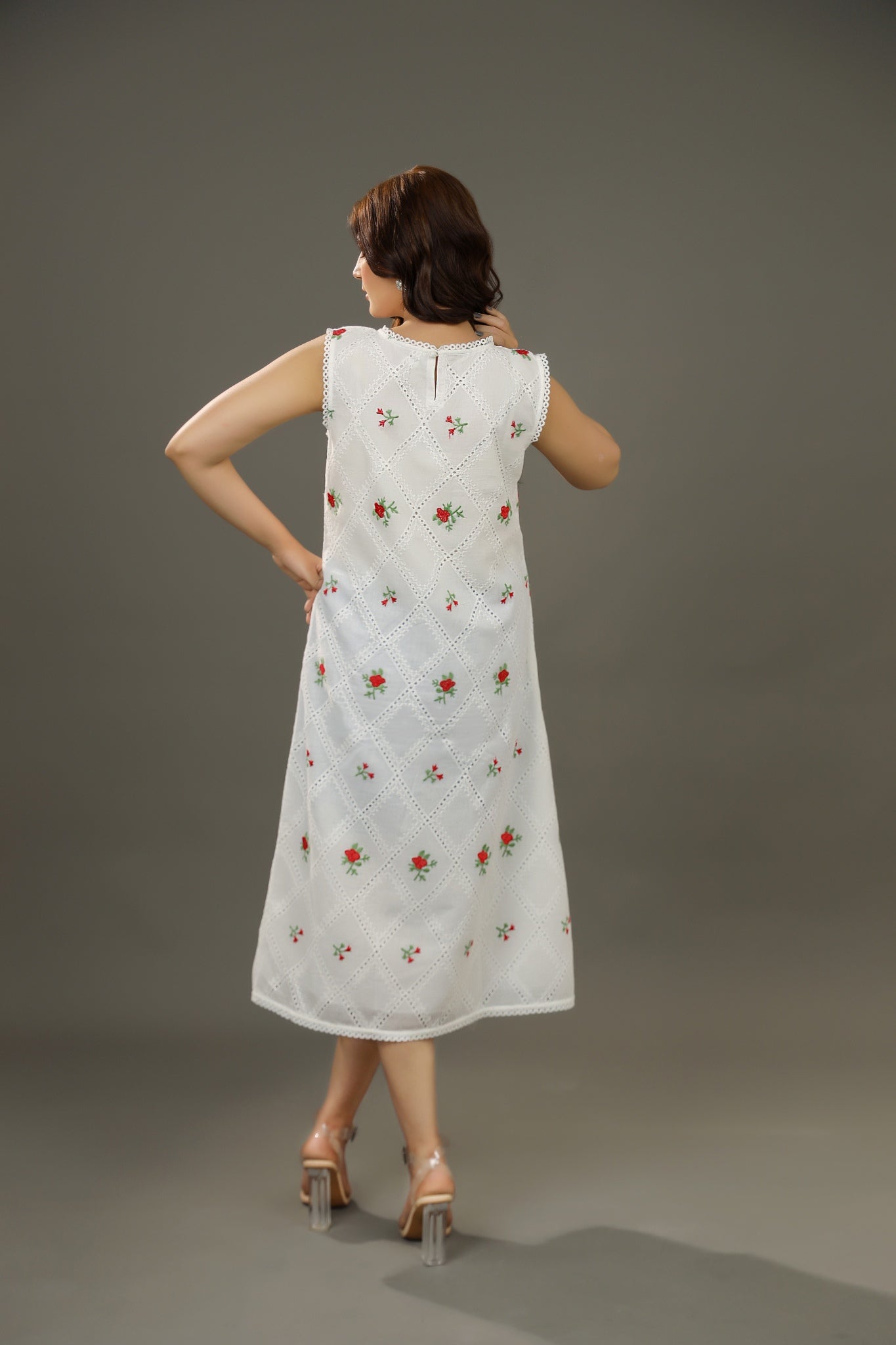 Woman wearing a white dress with floral patterns Organic-_cotton-white-summer-woman-dress-red-floral-backside