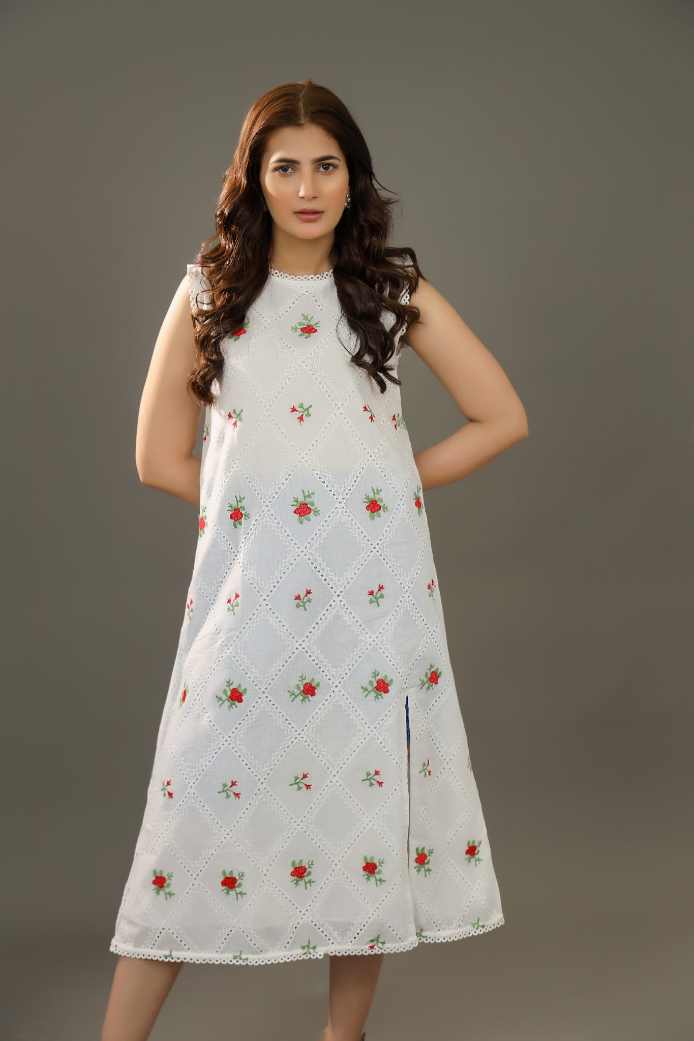 Woman wearing a white dress with floral patterns Organic-_cotton-white-summer-woman-dress-red-floral-frontside