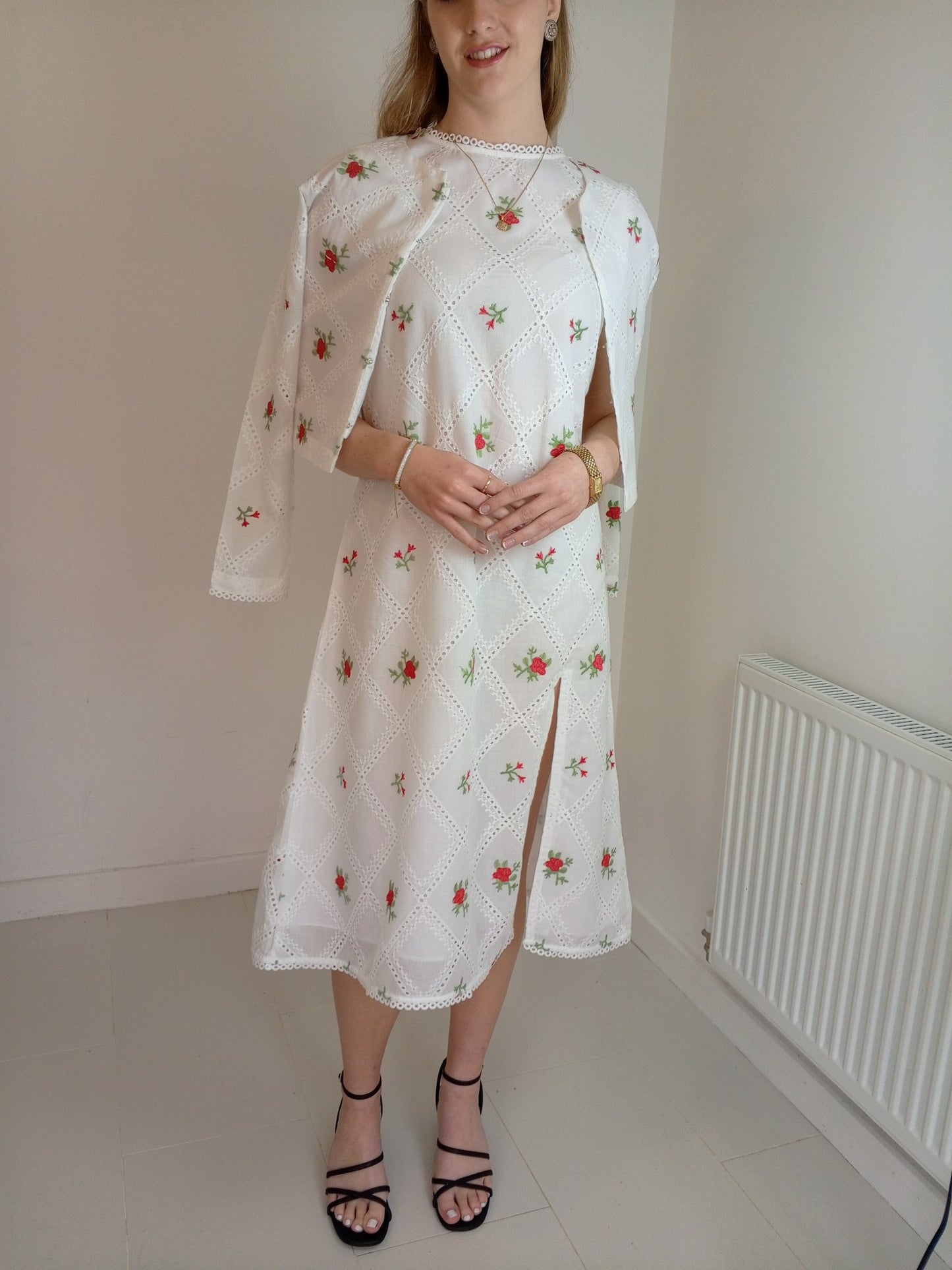 Woman wearing a white floral dress with a slit,Premium-organic-cotton-summer-woman-top-floral-red-embroidery-fullsleeve-matching jacket with dress