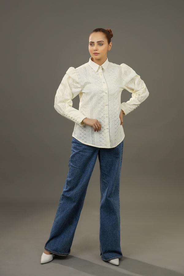 Woman wearing a white blouse and blue jeans against a gray background.-Embroidered  summer-women-Shirt-Relaxed body fit-Structured collar-Pearl buttons-Unlined-Long balloon sleeve with long cuffs-Fabric: 100% Cotton