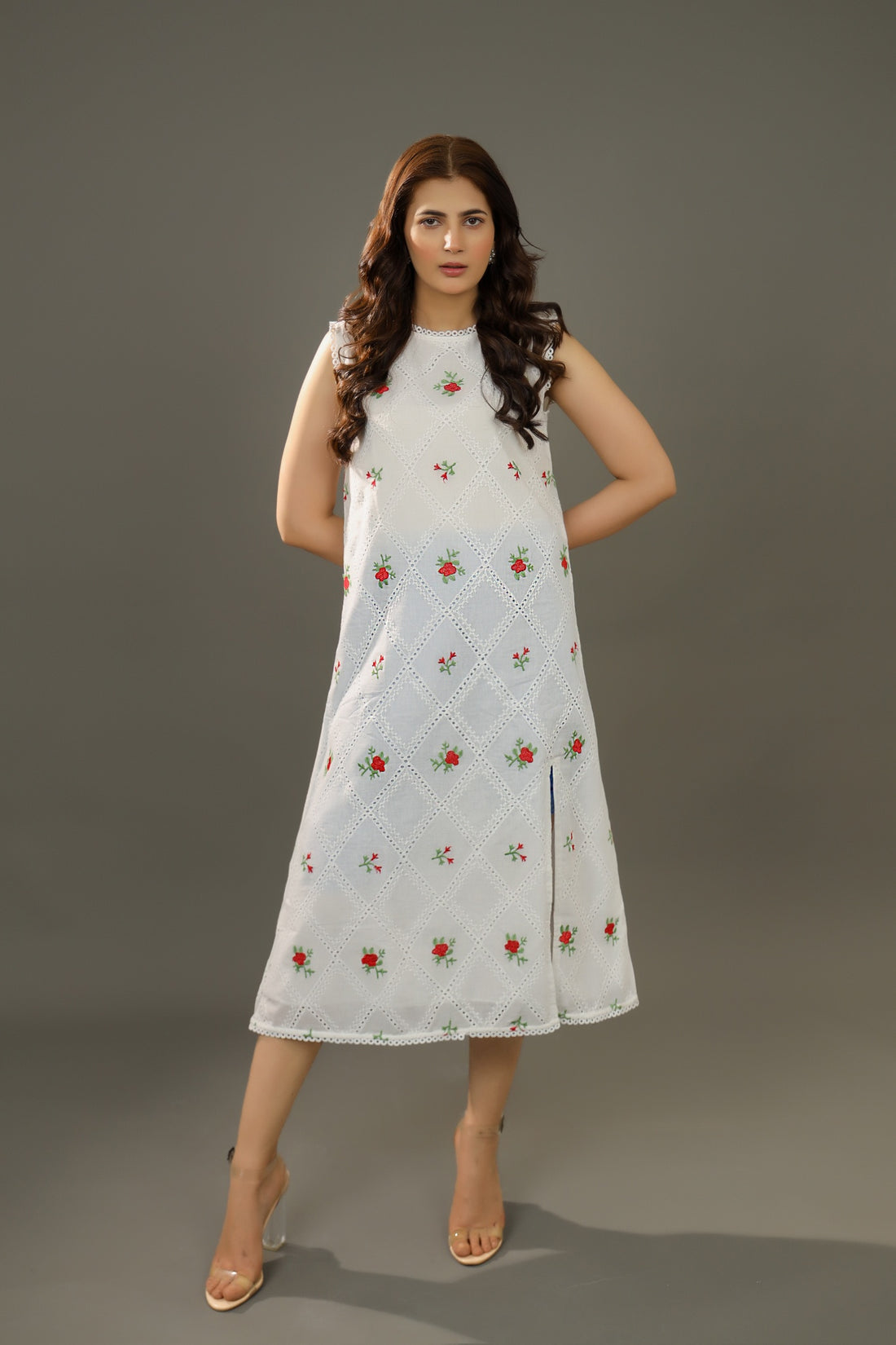 A woman wearing an Organic-_cotton-white-summer-woman-dress-red-floral