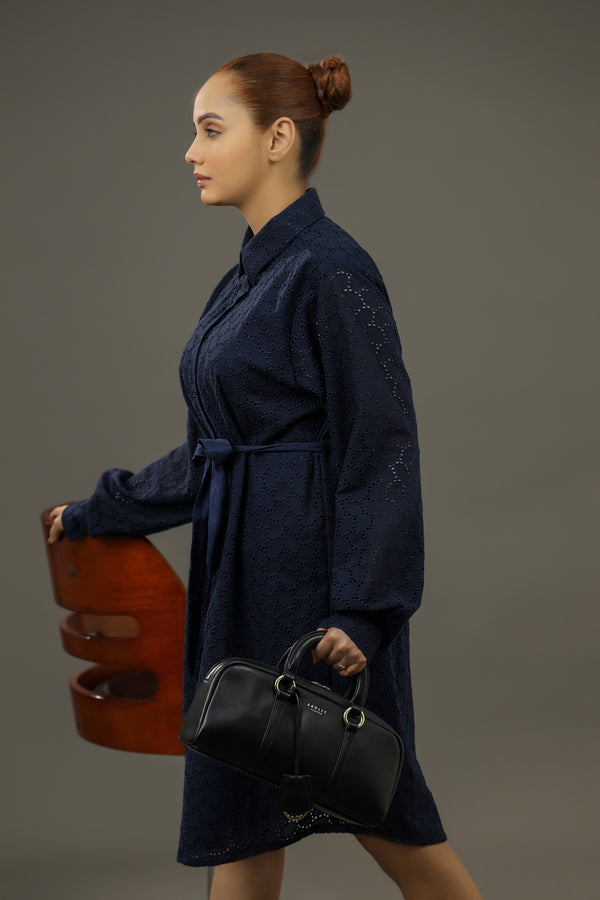 Woman in a dark blue coat holding a black bag.Premium-organic-cotton-summer-woman-top-floral--embroidery-fullsleeve-shirtdress-blue-sideview