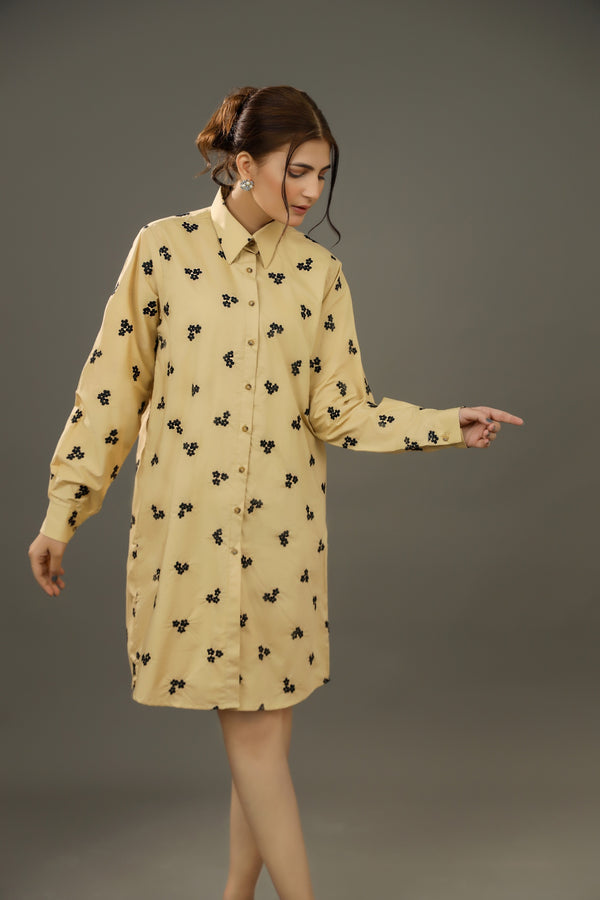 Woman wearing a yellow dress with black floral pattern against a gray backgroundPremium-organic-cotton-summer-woman-top-floral--embroidery-fullsleeve-shirtdress-side-closeup