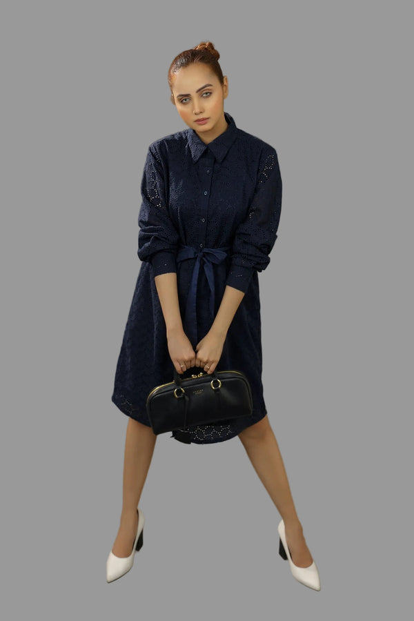 Woman in a navy dress holding a black handbag .Premium-organic-cotton-summer-woman-top-floral-embroidery-fullsleeve-shirtdress-topview-closeup