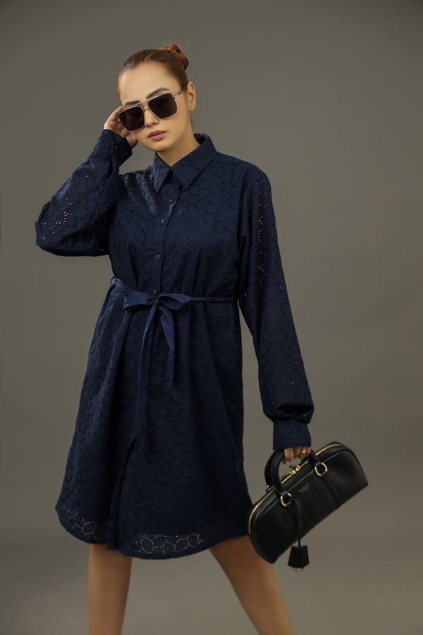 Woman wearing a navy blue dress with a belt, holding sunglasses and a black handbag Premium-organic-cotton-summer-woman-top-floral--embroidery-fullsleeve-shirtdress