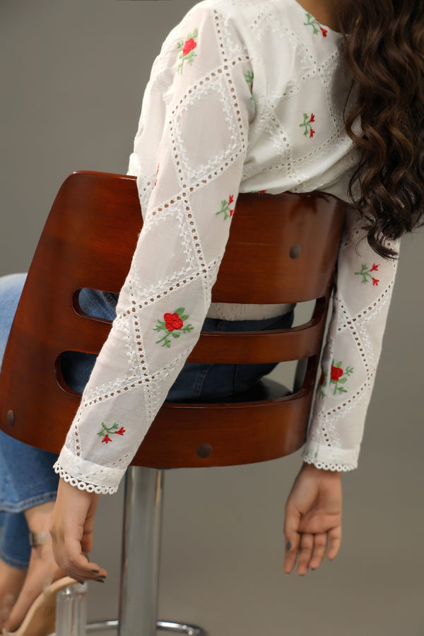Person wearing a white embroidered blouse . Premium-organic-cotton-summer-woman-top-floral-red-embroidery-fullsleeve-closeup