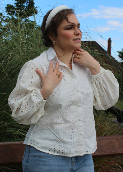 eyelet embroidery detail on white cotton blouse-side view